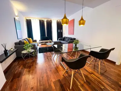 a living room with a glass table and chairs at Baron Suites in Valencia