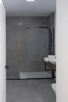 a glass shower in a bathroom with a sink at VLC HOST - Duque de Gaeta in Valencia
