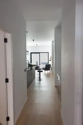 a white hallway with a kitchen and a living room at VLC HOST - Duque de Gaeta in Valencia