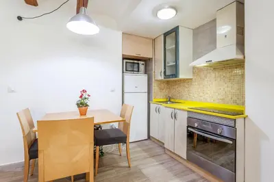 a kitchen with a table and a dining room at apartamento con terraza in Valencia