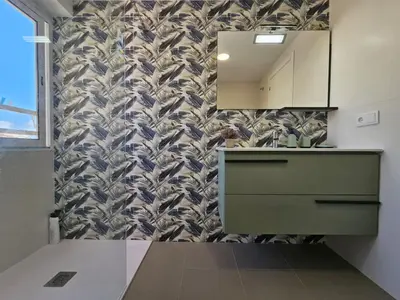 a bathroom with a sink and a mirror on a wall at Apartamento a pie de playa I in Faro de Cullera