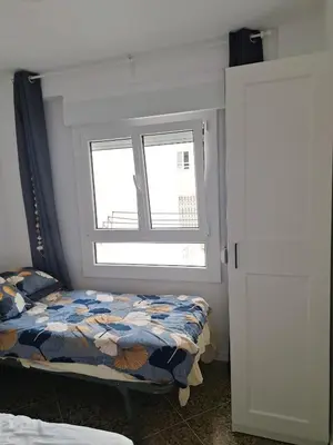 a bedroom with a bed and a window at Mar y castillo in Cullera