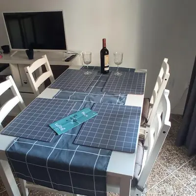 a table with a bottle of wine and two glasses at Mar y castillo in Cullera