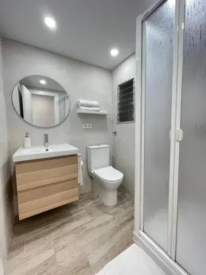 a bathroom with a toilet and a sink and a mirror at NUEVO, a 60 metros de la playa y con vistas laterales al mar in Cullera