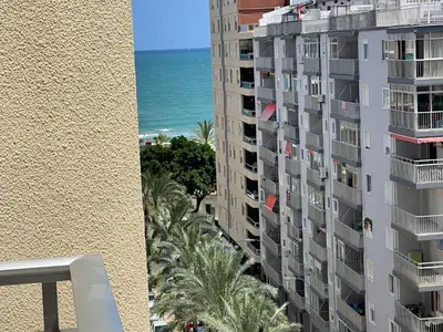 a view of the ocean from the balcony of a building at NUEVO, a 60 metros de la playa y con vistas laterales al mar in Cullera