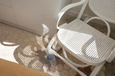 a white chair sitting on a floor next to a counter at SingularStays San Valero in Valencia