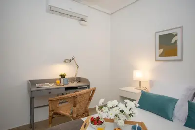a living room with a desk and a couch at SingularStays Gran Via in Valencia