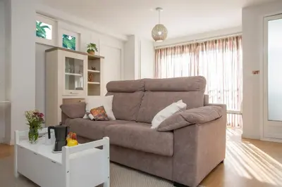 a living room with a brown couch and a table at SingularStays Benimaclet in Valencia