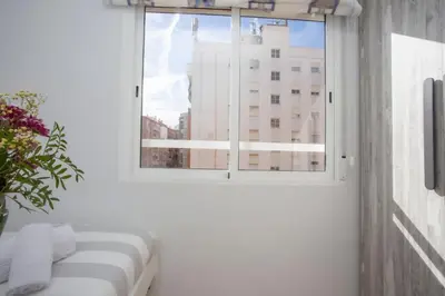 a white room with a window and a couch at SingularStays Benimaclet in Valencia