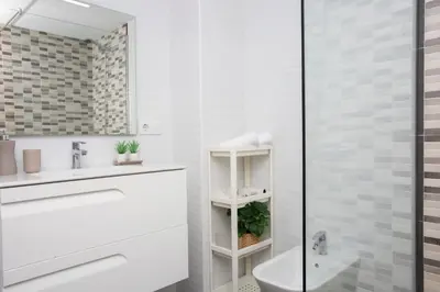 a white bathroom with a sink and a shower at SingularStays Benimaclet in Valencia