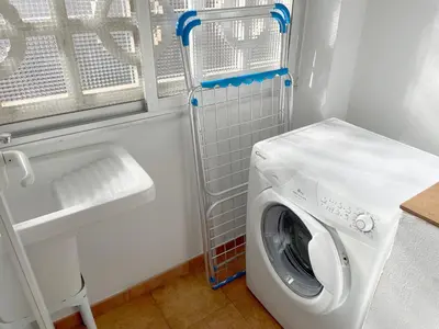 a washing machine in a laundry room with a sink at SingularStays Benimaclet in Valencia