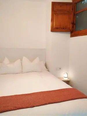 a bedroom with a white bed and a window at Estudio Pino en casco antiguo VALENCIAYOLE in Valencia