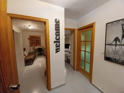 a hallway with a room with a camel sign on a wall at Apartamentos Bon Amb in Faro de Cullera