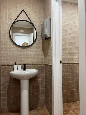 a bathroom with a sink and a mirror at UIM Planta baja Canovas del Castillo, PLAYA WIFI in Puerto de Sagunto