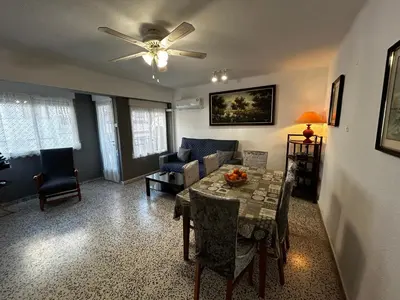 a living room with a table and a couch at RIU MAR Apartment Cullera in Cullera