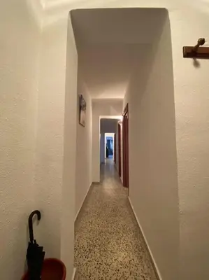 a hallway with a long corridor with a white wall at RIU MAR Apartment Cullera in Cullera