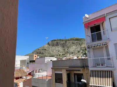 a view of a city with a hill in the background at RIU MAR Apartment Cullera in Cullera