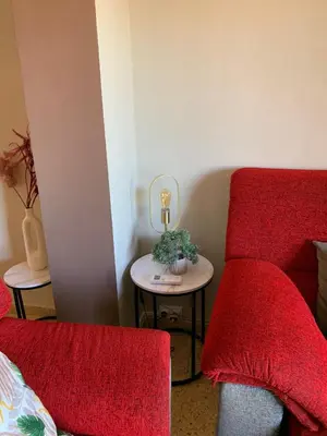a living room with a couch and a table and two mirrors at Sagunto in Sagunto