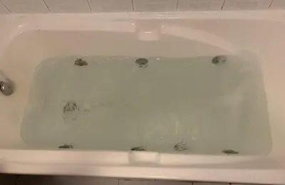 a white bath tub filled with water in a bathroom at Apartamento Castillo - Alquiler de temporada in Puerto de Sagunto