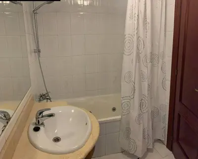 a bathroom with a sink and a bath tub at Apartamento Castillo - Alquiler de temporada in Puerto de Sagunto