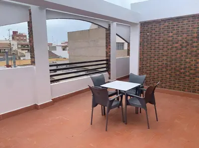 a room with a table and chairs on a balcony at Apartamento Castillo - Alquiler de temporada in Puerto de Sagunto