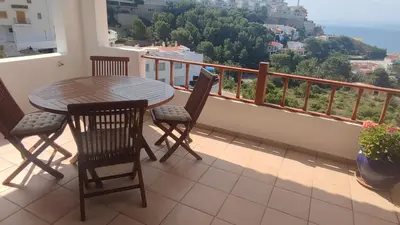 a table and chairs on a balcony with a view at Una casa con vistas in Faro de Cullera