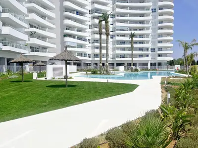 an external view of a large apartment building at Global Vacacional, Apartamento con terraza, vistas al mar y a la piscina in Canet de Berenguer