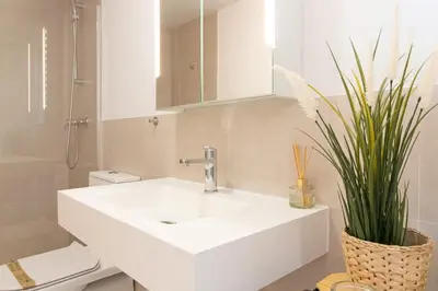 a bathroom with a white sink and a toilet at Global Vacacional, Moderno apartamento con terraza en Gran Canet in Canet de Berenguer