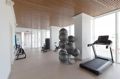 a room with a gym with a treadmill and balloons at Global Vacacional, Moderno apartamento con terraza en Gran Canet in Canet de Berenguer