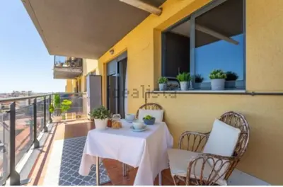 a table and chairs on the balcony of a building at Vacaciones perfectas. in Paterna