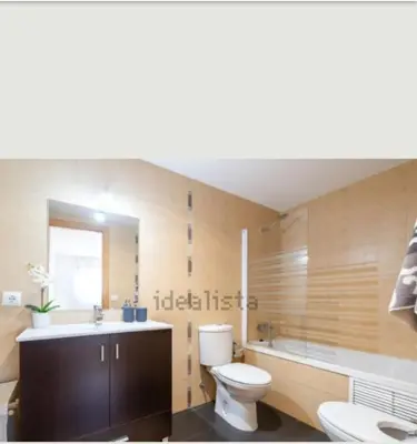 a bathroom with a toilet and a tub and a sink at Vacaciones perfectas. in Paterna
