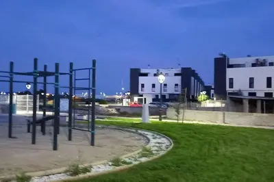 a playground in a park in front of some buildings at Terraced house in natural essence in Favareta