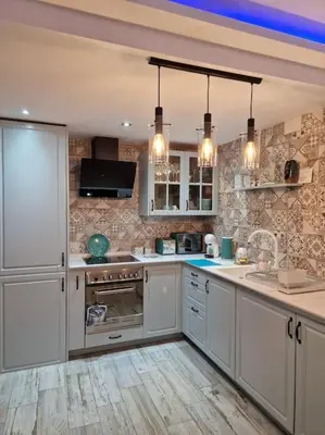 a kitchen with white cabinets and a counter top at Cullera Confort Playa in Cullera