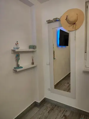 a hallway with a white door and a wooden floor at Cullera Confort Playa in Cullera