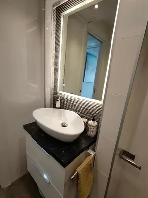 a bathroom with a sink and a toilet and a shower at Cullera Confort Playa in Cullera