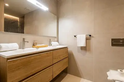 a bathroom with a sink and a mirror at North Station PEN-SUITES in Valencia