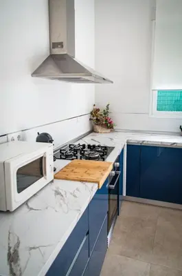a kitchen with a microwave and a stove top oven at Casa vacacional El Sol in Turís