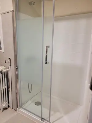 a shower with a glass door in a bathroom at La Casa Alandí con garaje privado in Sagunto