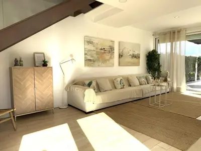 a living room with a couch and a television at Casa Del Mar, piscina privada frente al mar in Cullera