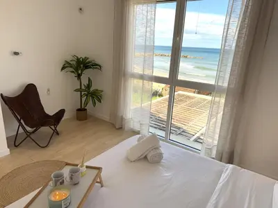 a bedroom with a bed and a view of the ocean at Casa Del Mar, piscina privada frente al mar in Cullera