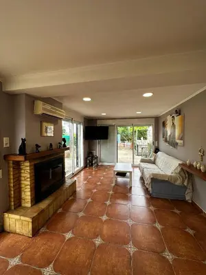 a living room with a couch and a fireplace at Villa Rosa Rasero in Serratella