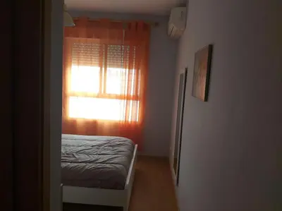 a small bedroom with a bed and a window at Luminoso piso en edificio de canet de berenguer in Canet de Berenguer