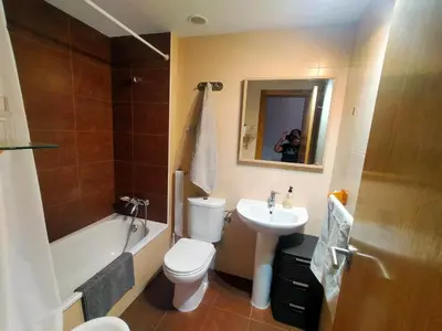 a bathroom with a toilet and a sink and a bath tub at Luminoso piso en edificio de canet de berenguer in Canet de Berenguer