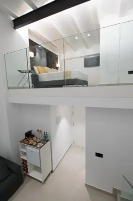 a white room with a bed and a couch at BET Apartments - Suites Puerto Valencia in Valencia