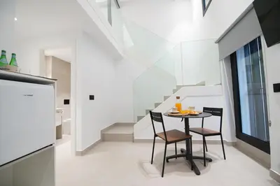 a dining room with a table and two chairs at BET Apartments - Suites Puerto Valencia in Valencia