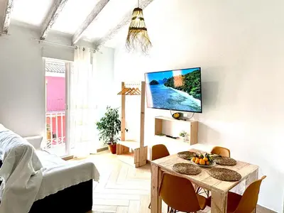 a living room with a table and a flat screen tv at Loft C El Ramellet in Alginet
