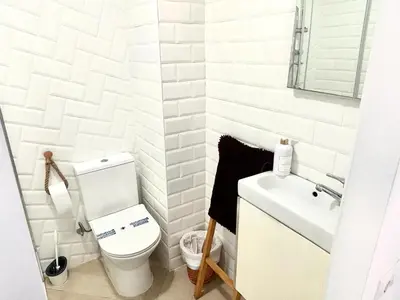 a white bathroom with a toilet and a sink at Loft C El Ramellet in Alginet