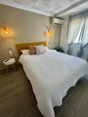 a bedroom with a large bed with a white bedspread at DJcumar Apartamento en Cullera comodo y bien ubicado in Cullera