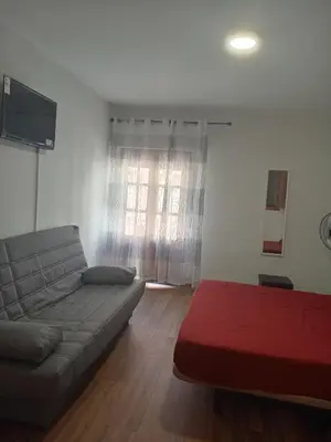 a living room with a couch and a window at Cantarranas in Requena