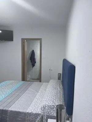 a bedroom with a blue bed and a mirror at Cantarranas in Requena